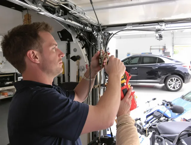 Ravenna Garage Door Repair safety certified technician performing cable replacement in Ravenna